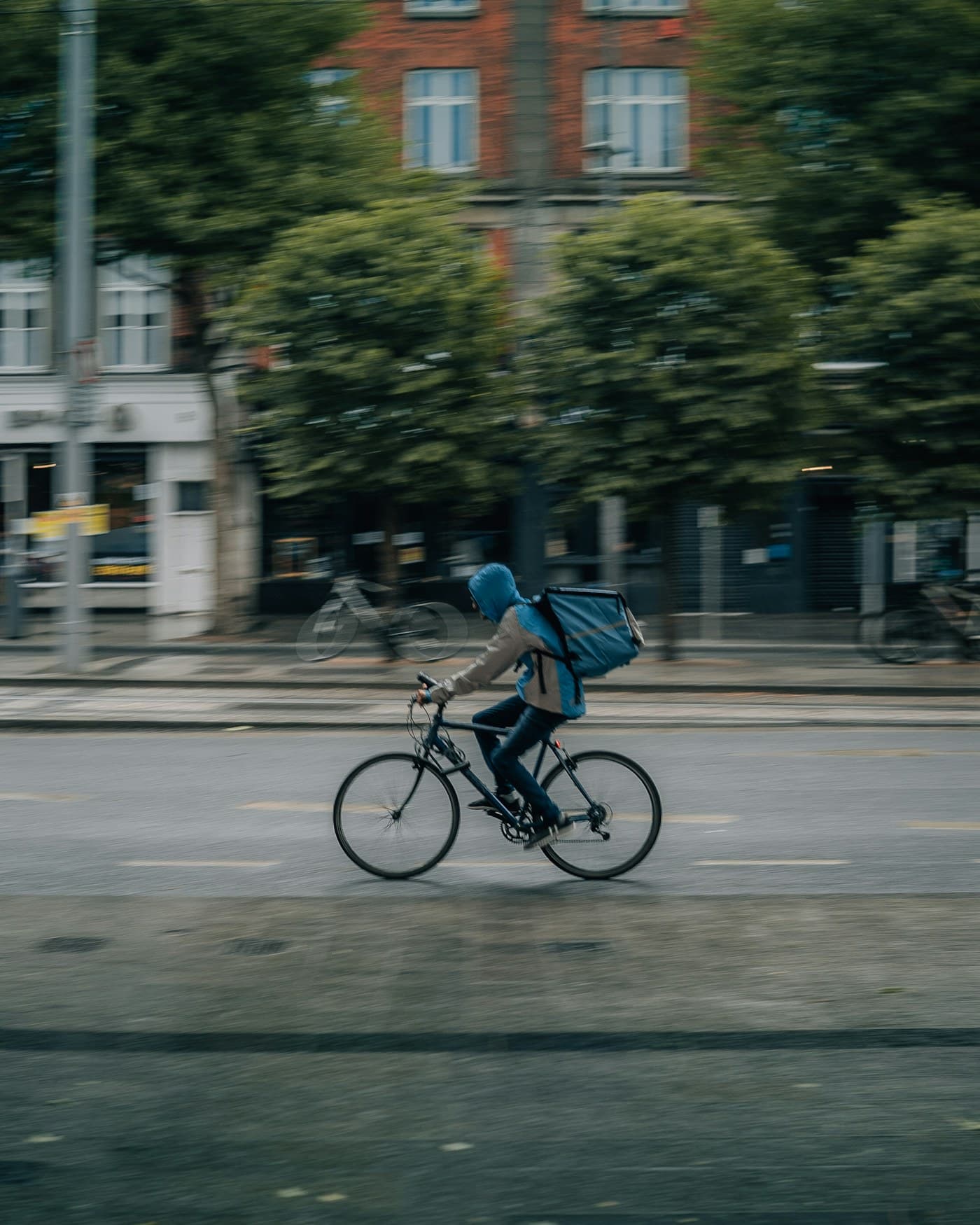 Cyclist riding alongside traffic on a city street