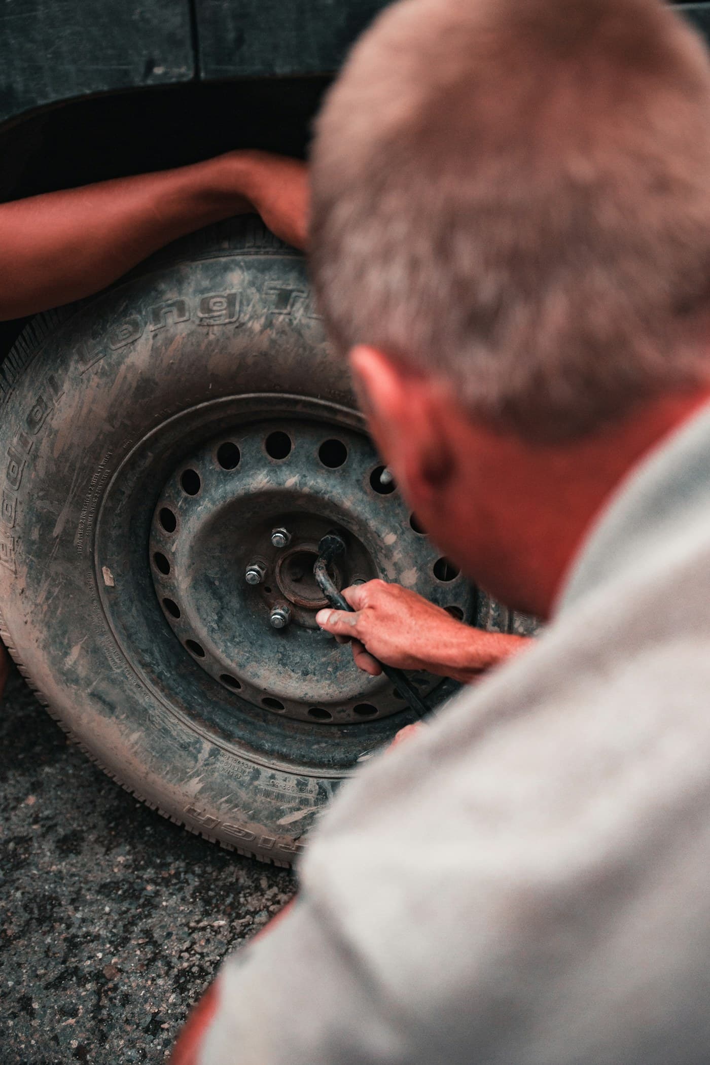 Person inspecting a tire and its components