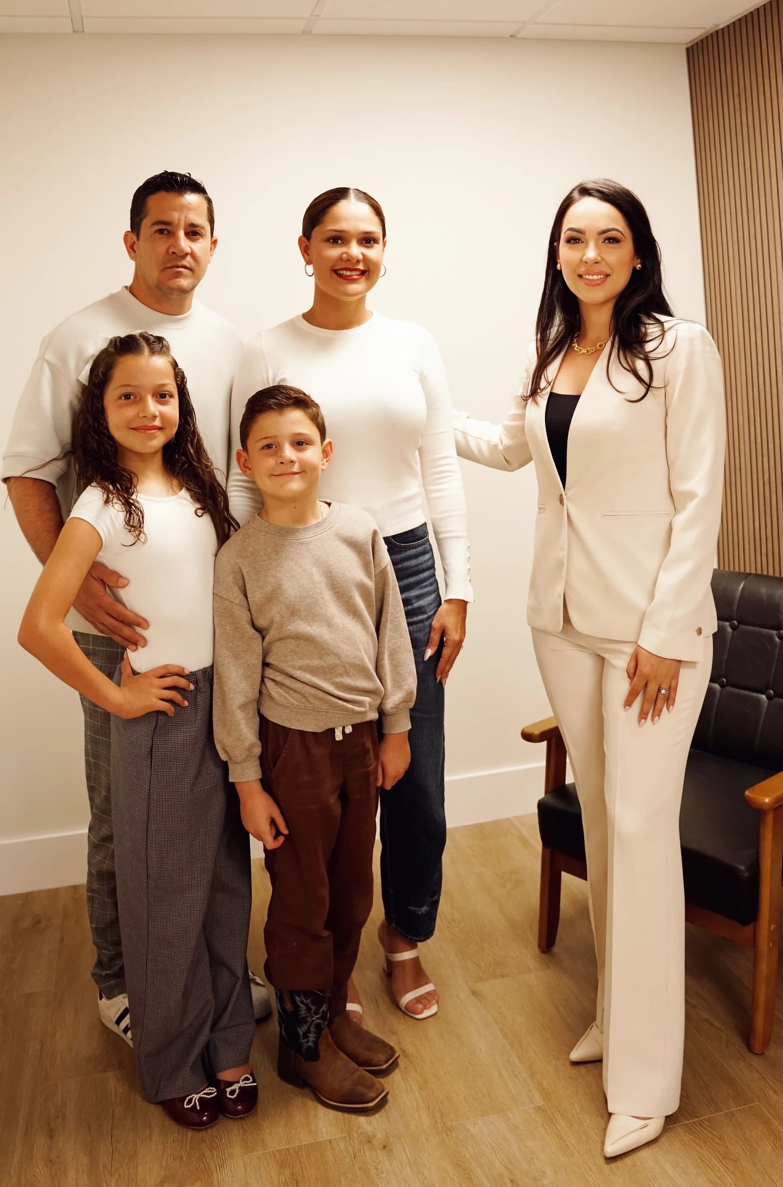 Kielan Saborit with a client family in the Saborit Law office